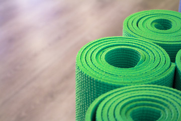 Fototapeta na wymiar Yoga mat on wooden floor