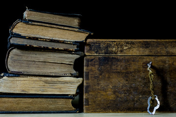 Old rolls and plans in folded paper rolls. Old book and case. Documents on an old wooden table.