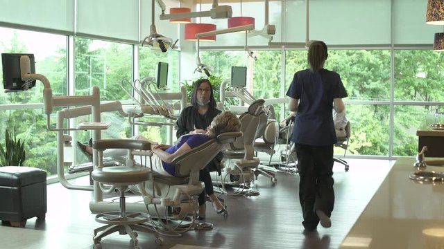 Wide shot of a dentist at work