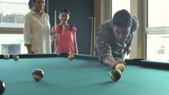 Push-out shot of a man hitting a cue ball