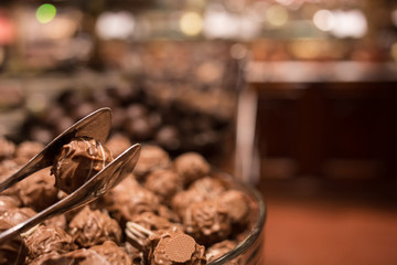Belgium tasty truffle delicious chocolate in a row, candy shop view. Food travel tourism.