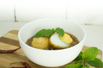 Egg with Tamarind Sauce on white wood