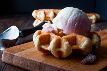 Belgium Waffle with ice cream on wooden surface.