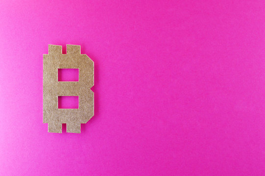 bitcoin currency symbol on pink background