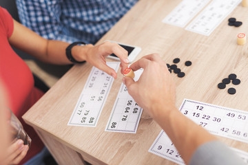 Naklejka premium The company of young people is playing in russian lotto.