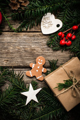 Christmas background with gingerbread, xmas tree and decoration on dark wooden board.