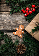 Christmas background with gingerbread, xmas tree and decoration on dark wooden board.