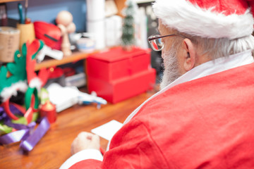 Santa Claus Father writing letters at his home