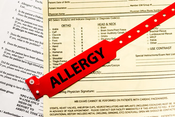 Allergy Bracelet Over Hospital Paperwork