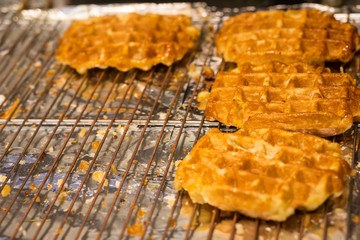 Cooking Belgian waffles in bakery - food background. Gaufres au sucre