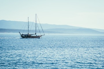 Fototapeta premium Sailboat on blue sea background