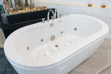 Bathroom interior in cozy colors with modern bathtub