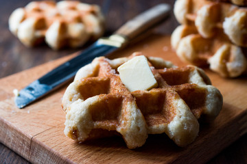 Belgium Waffle with Butter on wooden surface.