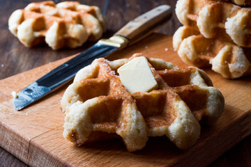 Belgium Waffle with Butter on wooden surface.