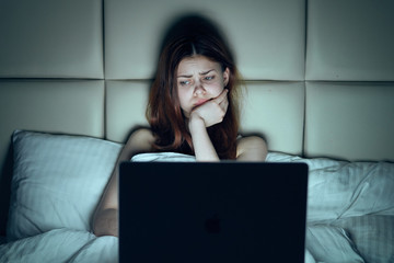 Fototapeta premium Beautiful young woman working at computer at home