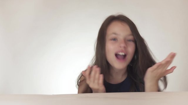 Beautiful naughty teenage girl joyfully sends kisses to the air on white background stock footage video