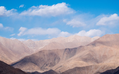 Closeup image of mountains and blue sky with clouds background in Ladakh , India