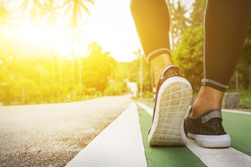 Athlete runner feet running on treadmill closeup on shoes
