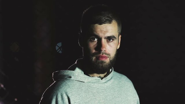 Intense male athlete looks into camera.