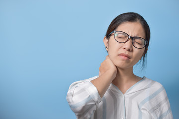 Asian woman standing and having neck pain.