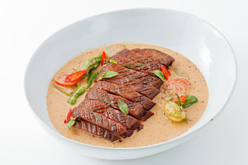 Sliced roasted duck in thai red curry ,Gaeng Ped Yang, with white background