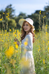 Asian beautiful woman relax in the field flower.