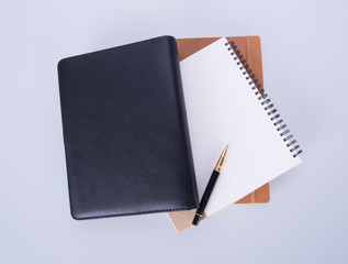 diary or notebook with pen on the background.