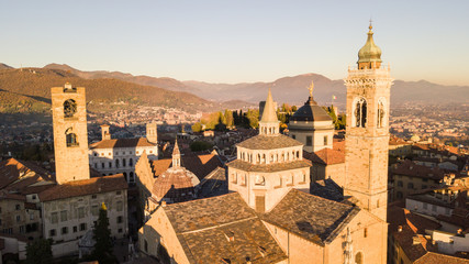 Fototapeta na wymiar Bergamo, Italy. Drone aerial view of the Old city. One of the beautiful city in Italy. Landscape on the city center and the historical buildings during the sunset