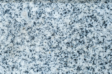Fototapeta na wymiar Texture, background, pattern. Granite stone. Padang Gray light gray granite with pronounced specks of black, quartz color, mined in Fujian province in the southeast of China.