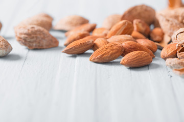 salted almonds in shell on wooden background