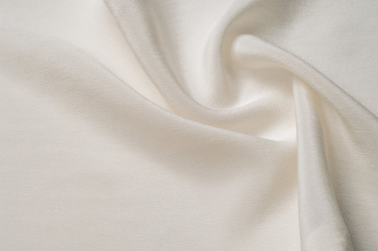 Texture background pattern. White silk fabric. Closeup of a rippled white silk fabric. Advertising space. Smooth elegant white silk can be used as a wedding background.