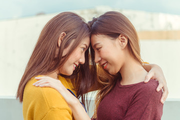 LGBT lesbian women couple moments happiness. Lesbian women couple together outdoors concept. Lesbian couple embraced together relation fall in love. Two asian women having fun together at rooftop.