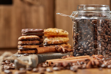 Aroma coffee candy chocolate cookies and spices on the wooden table. Christmas sweets. Dark wooden background. Top view. Close. Closeup.