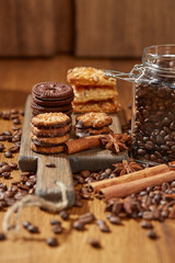 Aroma coffee candy chocolate cookies and spices on the wooden table. Christmas sweets. Dark wooden background. Top view. Close. Closeup.