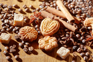 Fototapeta na wymiar Aroma coffee chocolate cookies and spices on the wooden table. Dark wooden background. Top view. Close. Closeup.