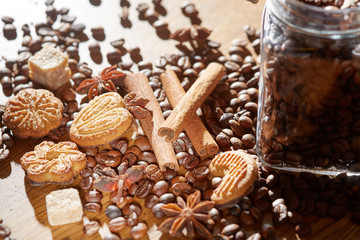 Aroma coffee chocolate cookies and spices on the wooden table. Dark wooden background. Top view. Close. Closeup.