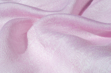 Texture, background, pattern. Cloth silk pink. English pink fabric with pink tones and white small floral pattern