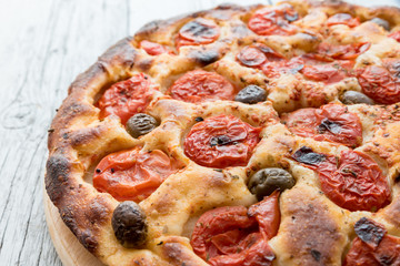 Focaccia typical of Bari Italy with tomatoes and olive