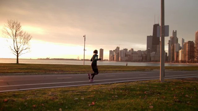 Woman is running in the park. Morning Sunrise.