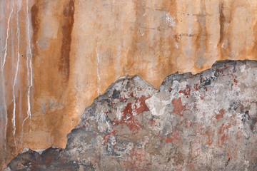 shabby old plaster wall with crack and spots from water