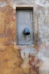 old plaster wall with protruding plastic pipe