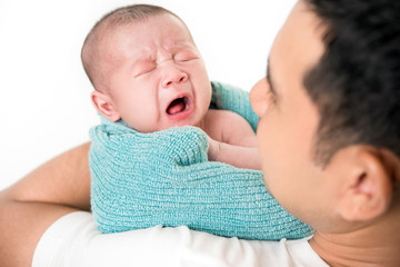 Young dad with cute little newborn baby child in his arms