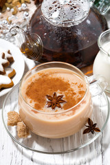 cup of hot spicy masala tea and Christmas cookies on white background, closeup top view