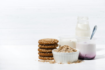 fruit yoghurt and oatmeal cookies - healthy food on white table