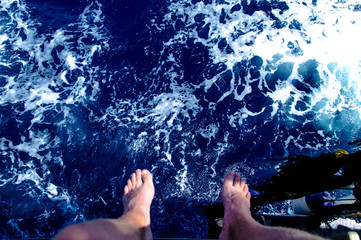 Fototapeta na wymiar Feet on the background of water