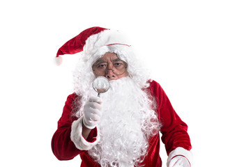 Portrait of santa looked with curiosity through a magnifying glass on camera isolated on white background.