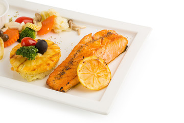 Grilled Salmon with garlic and herb ,lemon isolated on white background