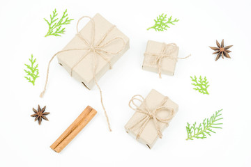 Christmas gift boxes collection by brown craft paper tied rope bow with pine branches on white background.