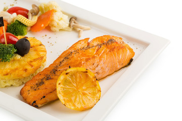 Grilled Salmon with garlic and herb ,lemon isolated on white background