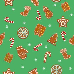 Beautiful Christmas ginger cookies, ginger cookies and candies on a green background. Seamless texture background.